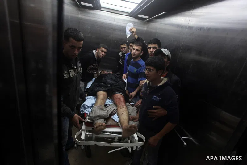 A wounded Palestinian is wheeled on a stretcher at a hospital in Gaza City following Israeli shelling November 10, 2012. Israeli tank shells killed at least two Palestinians and wounded 20 in the Gaza Strip on Saturday a...