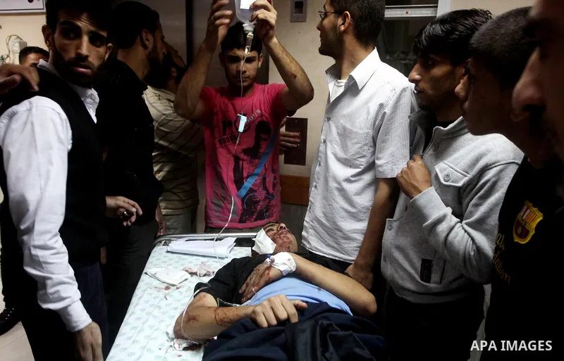 A wounded Palestinian is wheeled on a stretcher at a hospital in Gaza City following Israeli shelling November 10, 2012. Israeli tank shells killed at least two Palestinians and wounded 20 in the Gaza Strip on Saturday a...