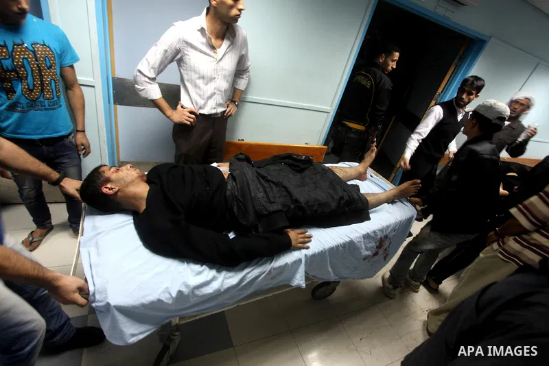 A wounded Palestinian is wheeled on a stretcher at a hospital in Gaza City following Israeli shelling November 10, 2012. Israeli tank shells killed at least two Palestinians and wounded 20 in the Gaza Strip on Saturday a...