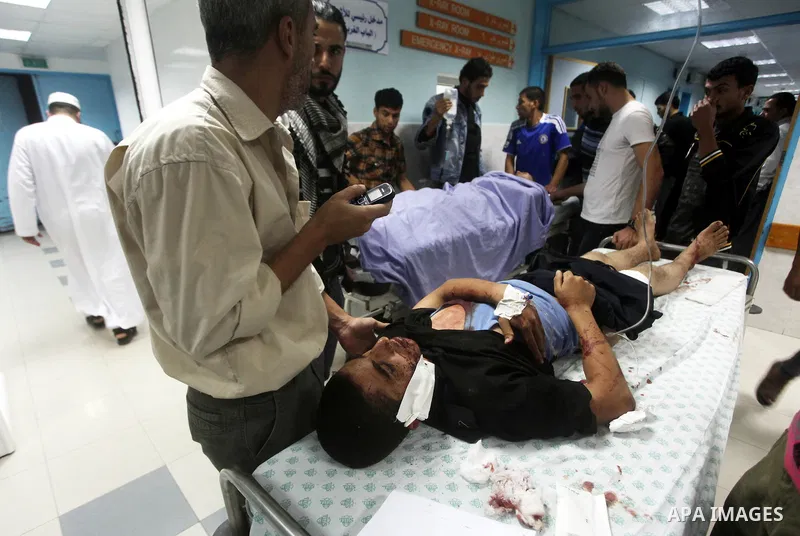 A wounded Palestinian is wheeled on a stretcher at a hospital in Gaza City following Israeli shelling November 10, 2012. Israeli tank shells killed at least two Palestinians and wounded 20 in the Gaza Strip on Saturday a...