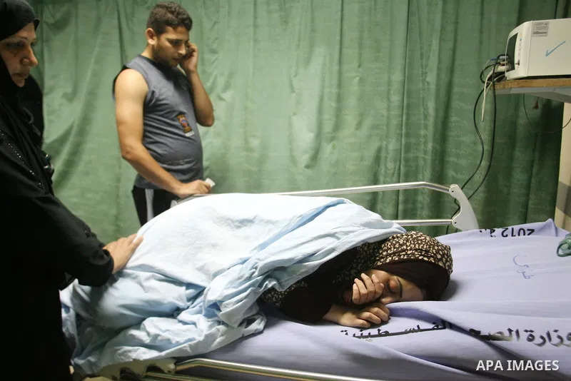 Palestinian women look at a relative at a hospital in Khan Yunis, in the southern Gaza Strip, after she was wounded during Israeli shelling as clashes erupted along the border on November 10, 2012. Two Palestinians were...