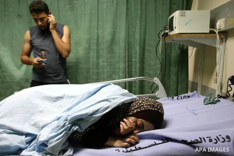 Palestinian women look at a relative at a hospital in Khan Yunis, in the southern Gaza Strip, after she was wounded during Israeli shelling as clashes erupted along the border on November 10, 2012. Two Palestinians were...