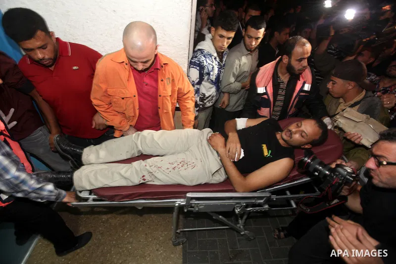 A wounded Palestinian is wheeled on a stretcher at a hospital in Gaza City following Israeli shelling November 10, 2012. Israeli tank shells killed at least two Palestinians and wounded 20 in the Gaza Strip on Saturday a...