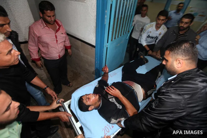 A wounded Palestinian is wheeled on a stretcher at a hospital in Gaza City following Israeli shelling November 10, 2012. Israeli tank shells killed at least two Palestinians and wounded 20 in the Gaza Strip on Saturday a...