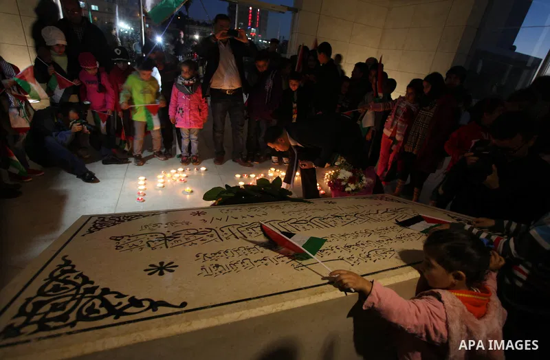 Palestinians gather to light candles at the mausoleum of their late leader Yasser Arafat in the West Bank city of Ramallah, on November 10, 2012, ahead of a ceremony marking the eighth anniversary of this death. The Pale...