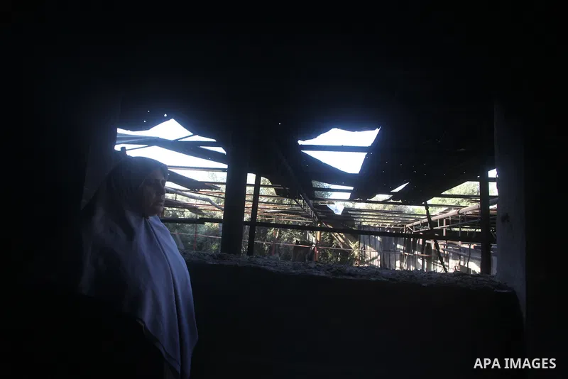 Palestinians inspect damage in their house damaged in an Israeli air strike in Gaza City November 11, 2012. An Israeli air strike killed a Palestinian militant in the Hamas-governed Gaza Strip on Sunday as a surge in cro...