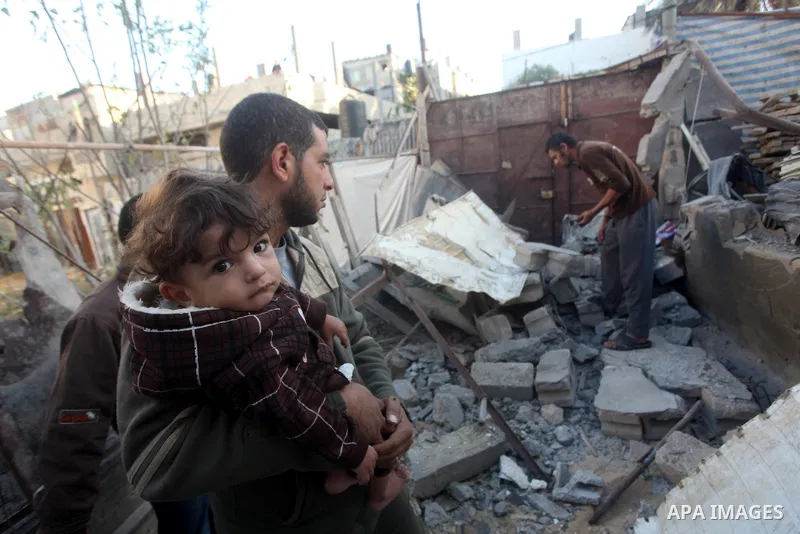 Palestinians inspect damage in their house damaged in an Israeli air strike in Gaza City November 11, 2012. An Israeli air strike killed a Palestinian militant in the Hamas-governed Gaza Strip on Sunday as a surge in cro...