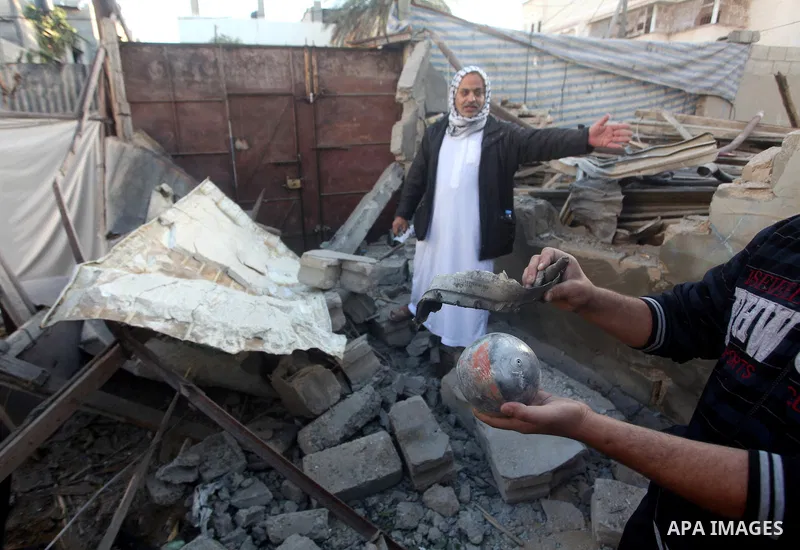 Palestinians inspect damage in their house damaged in an Israeli air strike in Gaza City November 11, 2012. An Israeli air strike killed a Palestinian militant in the Hamas-governed Gaza Strip on Sunday as a surge in cro...