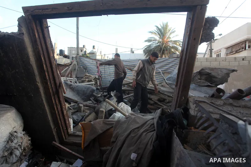 Palestinians inspect damage in their house damaged in an Israeli air strike in Gaza City November 11, 2012. An Israeli air strike killed a Palestinian militant in the Hamas-governed Gaza Strip on Sunday as a surge in cro...
