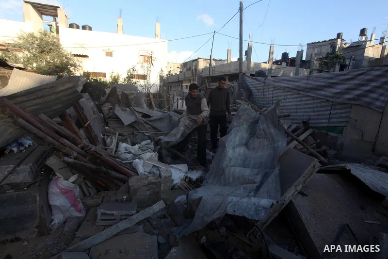Palestinians inspect damage in their house damaged in an Israeli air strike in Gaza City November 11, 2012. An Israeli air strike killed a Palestinian militant in the Hamas-governed Gaza Strip on Sunday as a surge in cro...