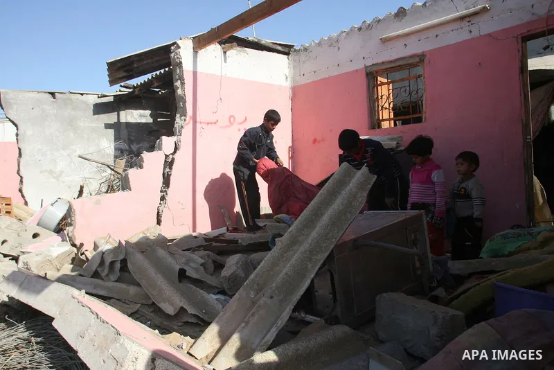 Palestinians inspect the damage to their home following an Israeli military air strike in Rafah town in the southern Gaza Strip, on November 11, 2012. The flare-up which began November 10, was one of the most serious sin...