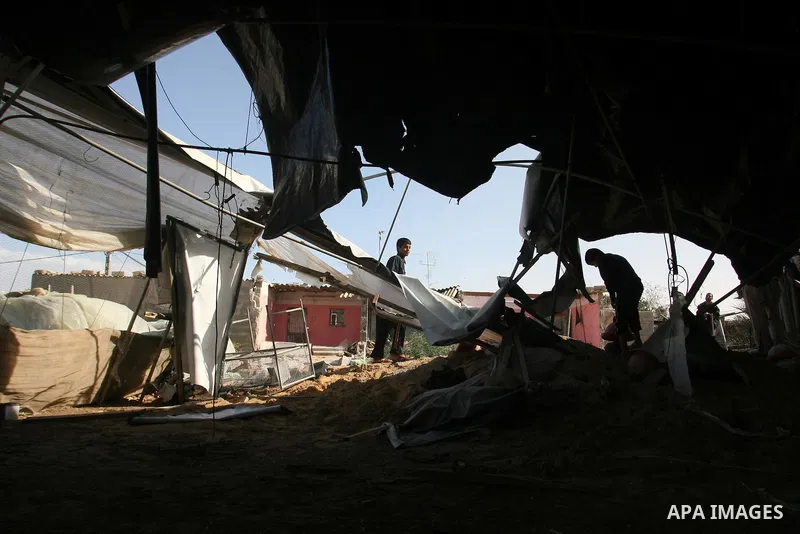 Palestinians inspect the damage to their home following an Israeli military air strike in Rafah town in the southern Gaza Strip, on November 11, 2012. The flare-up which began November 10, was one of the most serious sin...