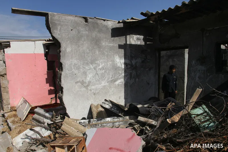 Palestinians inspect the damage to their home following an Israeli military air strike in Rafah town in the southern Gaza Strip, on November 11, 2012. The flare-up which began November 10, was one of the most serious sin...