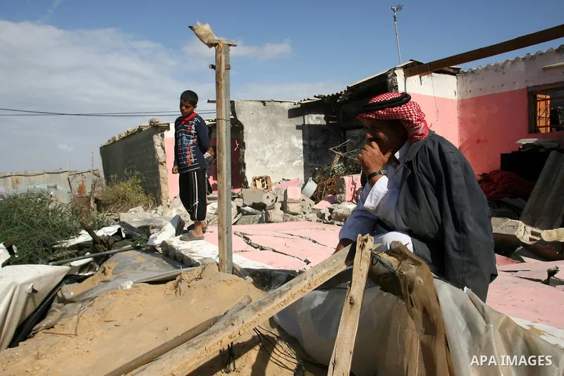 Palestinians inspect the damage to their home following an Israeli military air strike in Rafah town in the southern Gaza Strip, on November 11, 2012. The flare-up which began November 10, was one of the most serious sin...