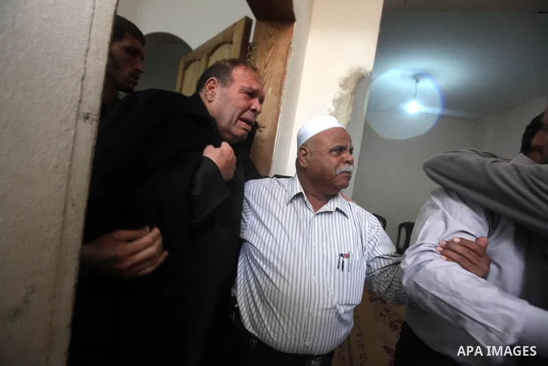 Palestinians relative the body of Islamic Jihad militant, Mohammed Shkukani, 19, mourn during his funeral at the Shati refugee camp in Gaza City, Sunday, Nov. 11, 2012. Hostilities along the Gaza-Israel border escalated...