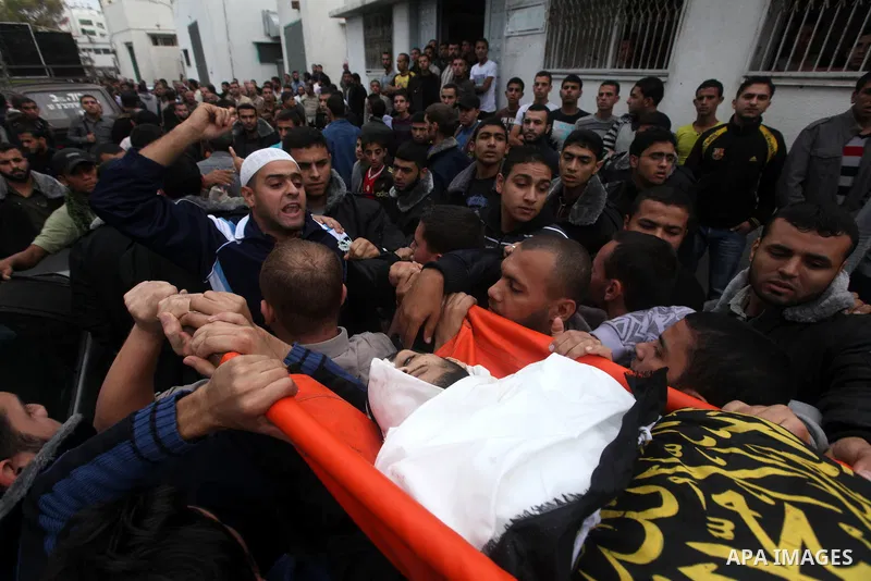 Palestinians carry the body of Islamic Jihad militant, Mohammed Shkukani, 19, during his funeral at the Shati refugee camp in Gaza City, Sunday, Nov. 11, 2012. Hostilities along the Gaza-Israel border escalated sharply o...