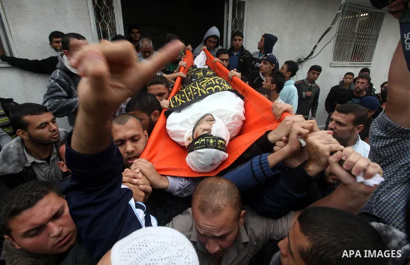 Palestinians carry the body of Islamic Jihad militant, Mohammed Shkukani, 19, during his funeral at the Shati refugee camp in Gaza City, Sunday, Nov. 11, 2012. Hostilities along the Gaza-Israel border escalated sharply o...