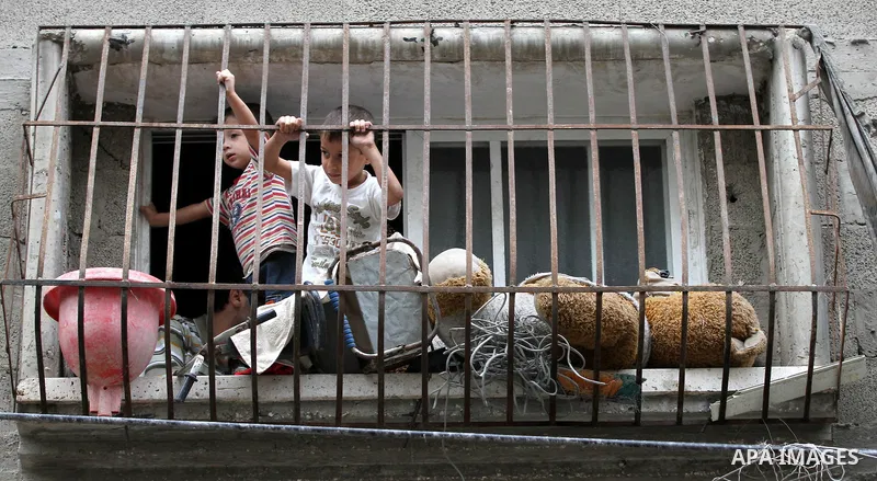 Palestinian children look through a window at the funeral at the Shati refugee camp in Gaza City, Sunday, Nov. 11, 2012. Hostilities along the Gaza-Israel border escalated sharply over the weekend, with bombardments from...