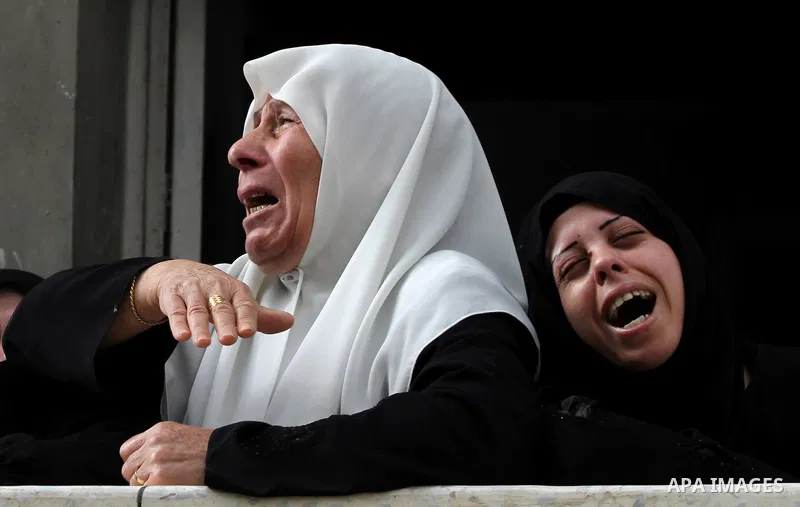 Palestinian relatives of killed civilian Ahmad Dardasawy, 18, mourn during his funeral in Gaza City on November 11, 2012, after he was killed the day before in Israeli shelling as clashes erupted along the Israeli-Gaza S...