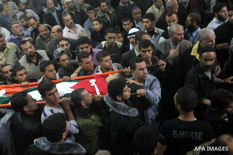 Mourners carry the body of killed Palestinian civilian Ahmad Dardasawy, 18, during his funeral in Gaza City on November 11, 2012 , the day after he was killed in Israeli shelling as clashes erupted along the Isreali-Gaza...