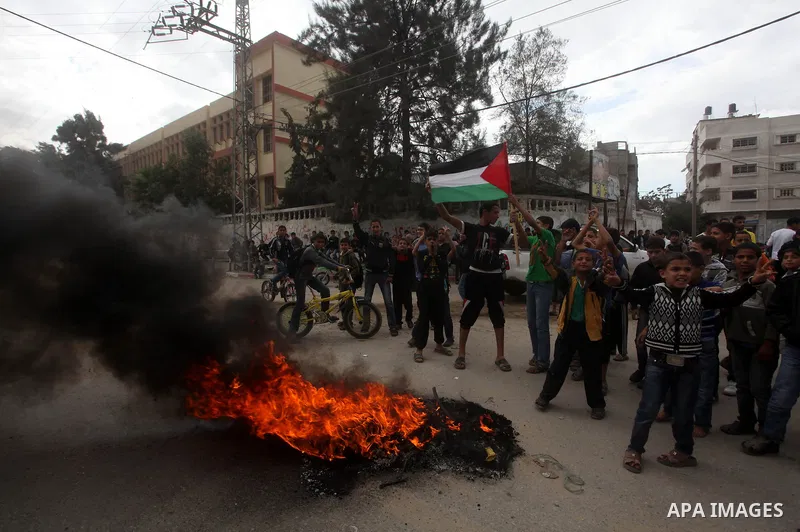 Palestinians burn tires during a funeral in Gaza City on November 11, 2012 , the day after he was killed in Israeli shelling as clashes erupted along the Isreali-Gaza Strip border. The flare-up was one of the most seriou...