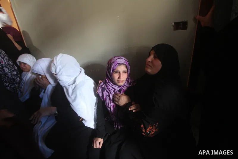 Palestinian women grieve during the funeral of Matar Abu Ata, 20, killed in an Israeli airstrike overnight, in Gaza City, Sunday, Nov. 11, 2012. While cross-border fighting is a common occurrence, hostilities spiraled sh...