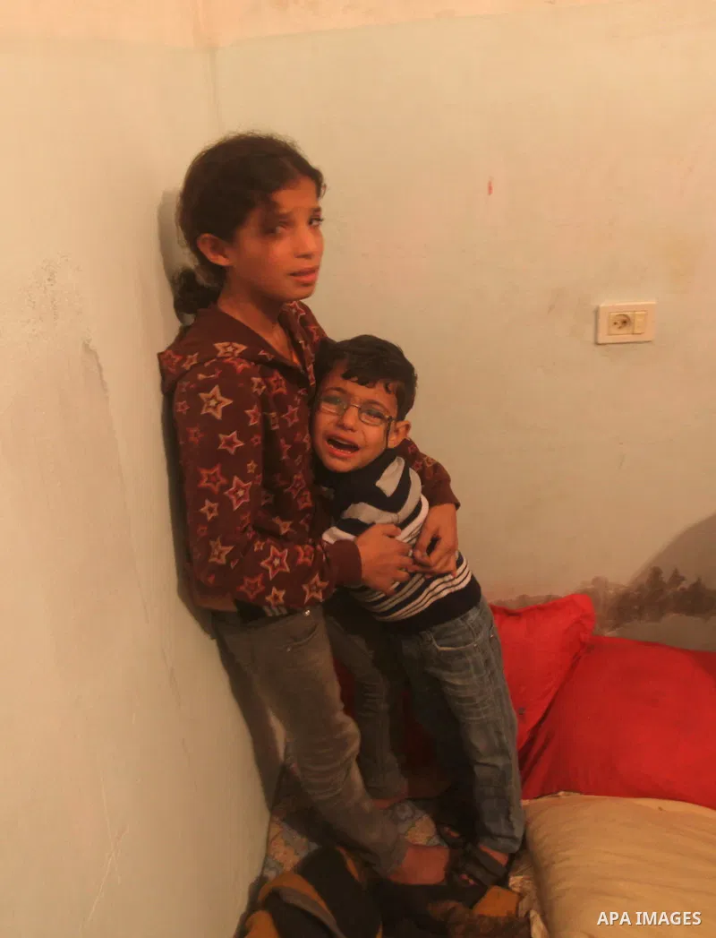 Palestinian children grieve during the funeral of Matar Abu Ata, 20, killed in an Israeli airstrike overnight, in Gaza City, Sunday, Nov. 11, 2012. While cross-border fighting is a common occurrence, hostilities spiraled...