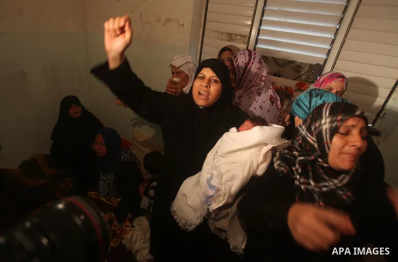 Palestinian women grieve during the funeral of Matar Abu Ata, 20, killed in an Israeli airstrike overnight, in Gaza City, Sunday, Nov. 11, 2012. While cross-border fighting is a common occurrence, hostilities spiraled sh...