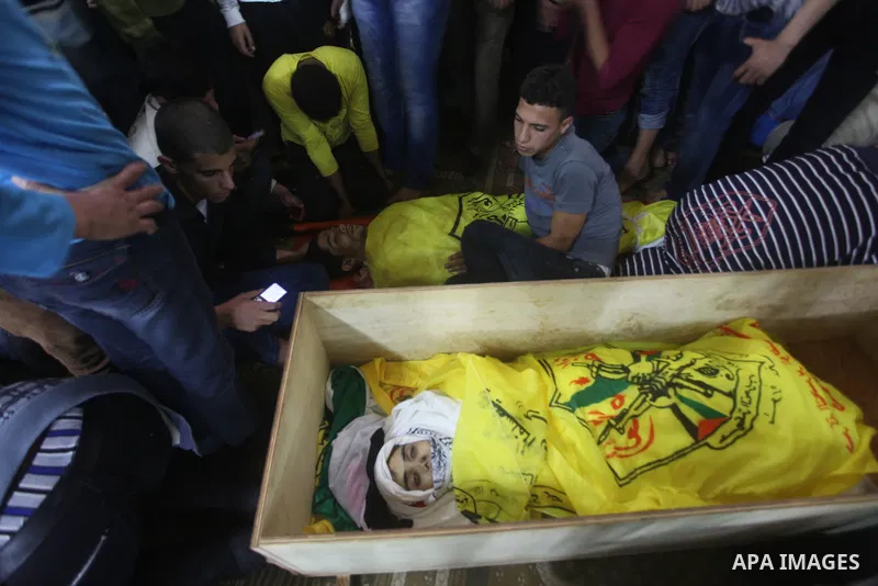 Mourners carry the body of Palestinian Matar Abu Ata, 20, killed in a recent Israeli strike, during his funeral in Gaza City, Sunday, Nov. 11, 2012. While cross-border fighting is a common occurrence, hostilities spirale...