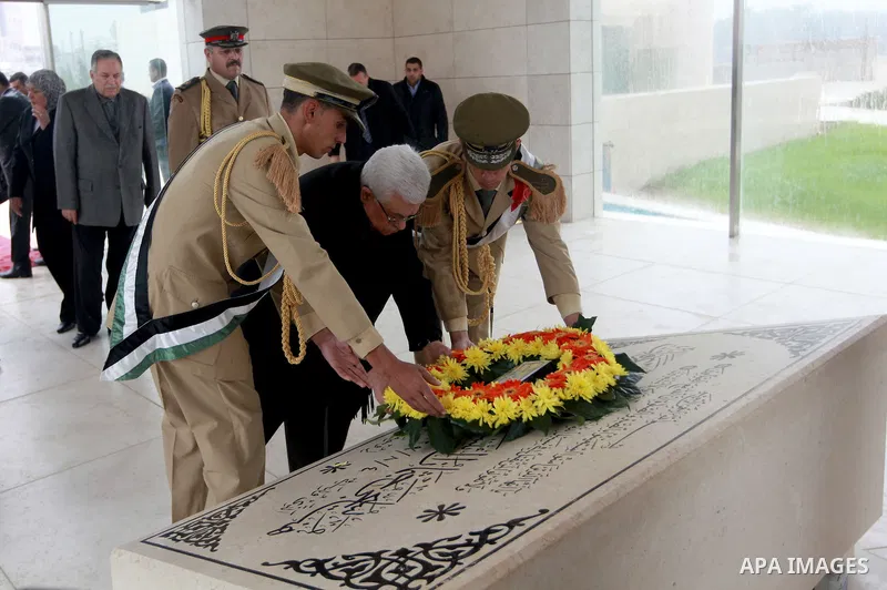 Palestinian President Mahmoud Abbas (C) lays a wreath over late leader Yasser Arafat grave prior the official ceremony of marking Arafat's 8th Anniversary of his death, in the West Bank city of Ramallah on Nov. 11, 2012....