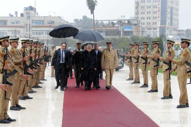 Palestinian President Mahmoud Abbas (L) makes his way to late leader Yasser Arafat grave prior the official ceremony of marking Arafat's 8th Anniversary of his death, in the West Bank city of Ramallah on Nov. 11, 2012. P...