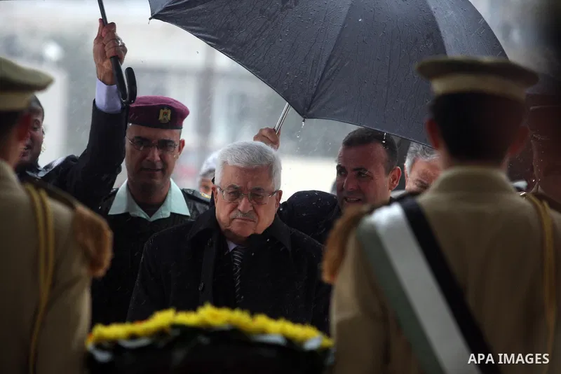 Palestinian President Mahmoud Abbas (L) makes his way to late leader Yasser Arafat grave prior the official ceremony of marking Arafat's 8th Anniversary of his death, in the West Bank city of Ramallah on Nov. 11, 2012.Ph...
