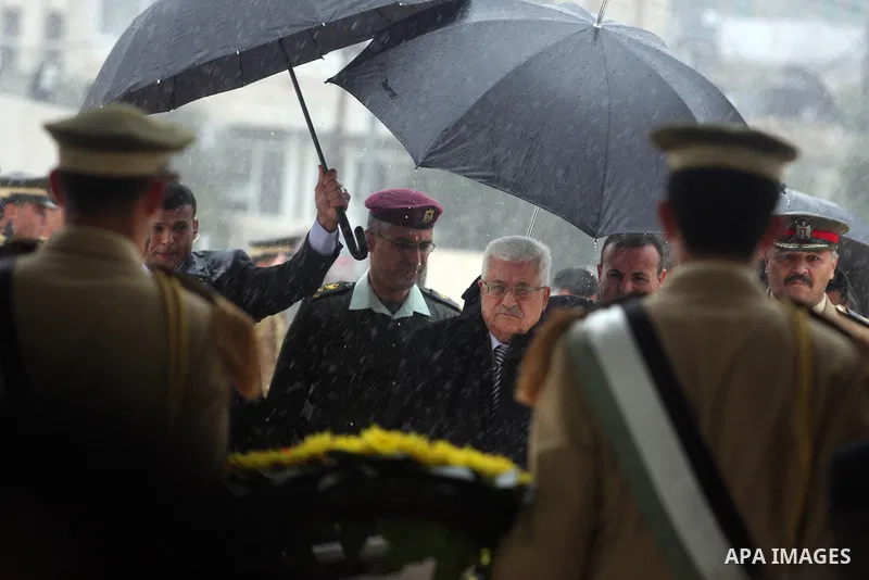 Palestinian President Mahmoud Abbas (L) makes his way to late leader Yasser Arafat grave prior the official ceremony of marking Arafat's 8th Anniversary of his death, in the West Bank city of Ramallah on Nov. 11, 2012.Ph...
