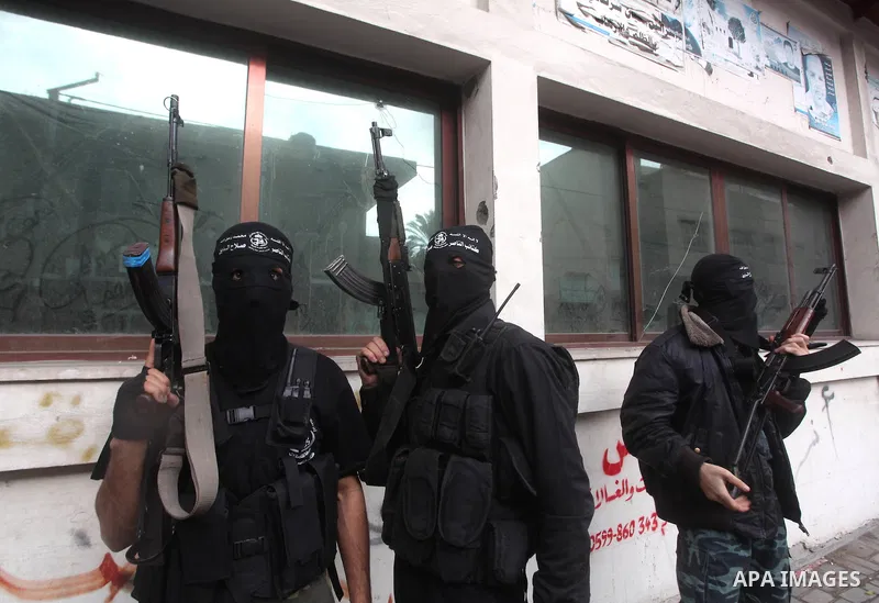 Palestinian masked gunmen, belonging to the Popular Resistance Committees (PRC), attend a press conference in Gaza City on November 11, 2012. The outbreak of violence was one of the most serious since Israel's devastatin...