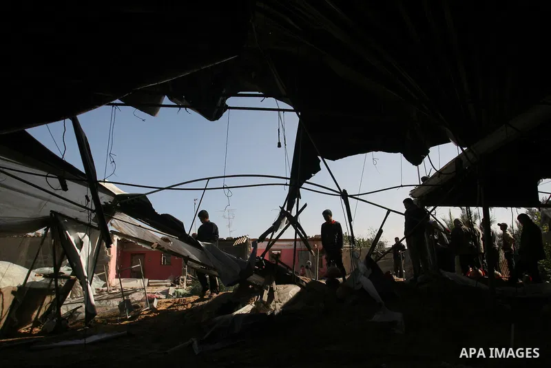 Palestinians inspect the damage to their home following an Israeli military air strike in Rafah town in the southern Gaza Strip, on November 11, 2012. The flare-up which began November 10, was one of the most serious sin...