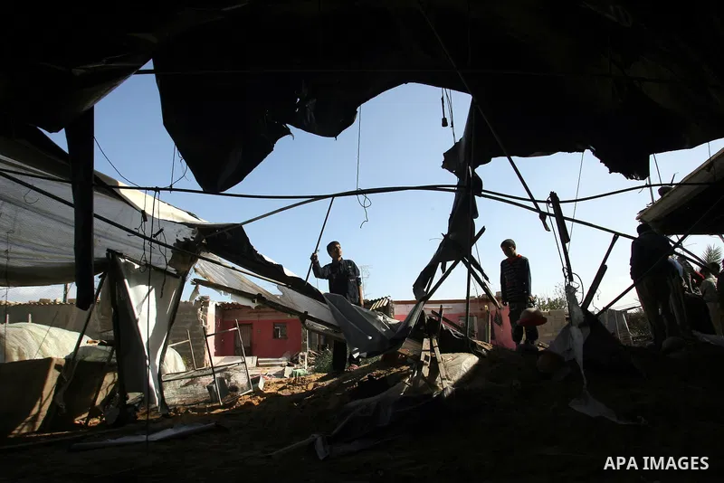 Palestinians inspect the damage to their home following an Israeli military air strike in Rafah town in the southern Gaza Strip, on November 11, 2012. The flare-up which began November 10, was one of the most serious sin...