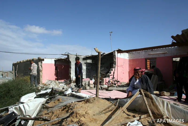 Palestinians inspect the damage to their home following an Israeli military air strike in Rafah town in the southern Gaza Strip, on November 11, 2012. The flare-up which began November 10, was one of the most serious sin...