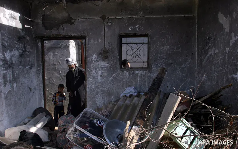 Palestinians inspect the damage to their home following an Israeli military air strike in Rafah town in the southern Gaza Strip, on November 11, 2012. The flare-up which began November 10, was one of the most serious sin...