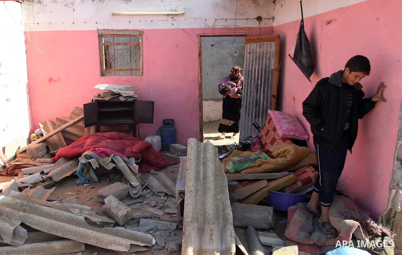 Palestinians inspect the damage to their home following an Israeli military air strike in Rafah town in the southern Gaza Strip, on November 11, 2012. The flare-up which began November 10, was one of the most serious sin...