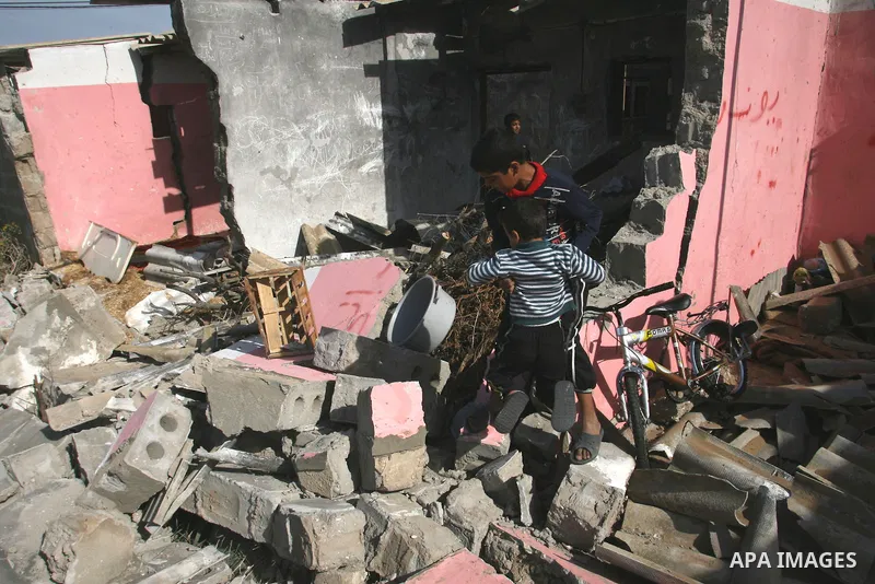Palestinians inspect the damage to their home following an Israeli military air strike in Rafah town in the southern Gaza Strip, on November 11, 2012. The flare-up which began November 10, was one of the most serious sin...