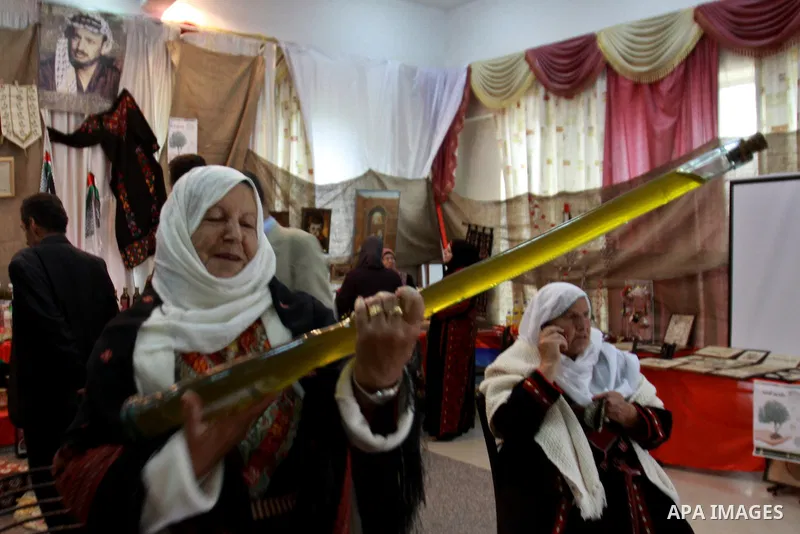 Palestinians woman participate in the opening of the Olive Festival in the in the West Bank of Salfit, on Nov. 11, 2012. Photo by Nedal Eshtayah