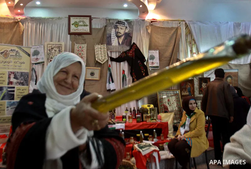 Palestinians woman participate in the opening of the Olive Festival in the in the West Bank of Salfit, on Nov. 11, 2012. Photo by Nedal Eshtayah