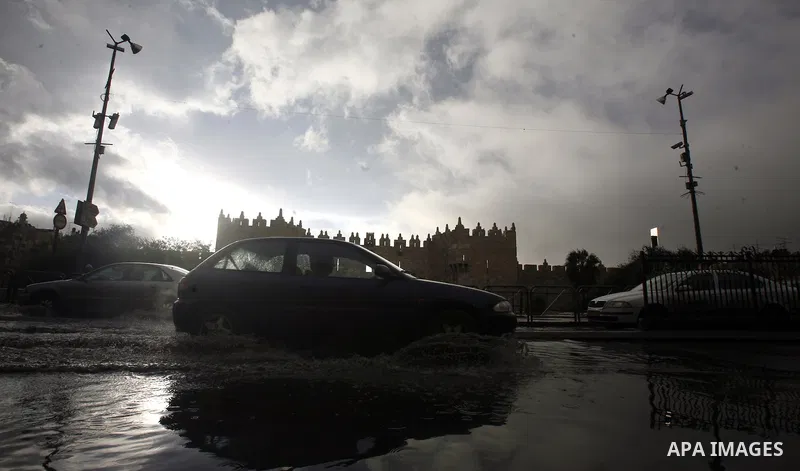 Cars cross a flooded street outside al-Aqsa Mosque compound, Islam's third holiest, in the old city of Jerusalem on November 12, 2012. Photo by Mahfouz Abu Turk