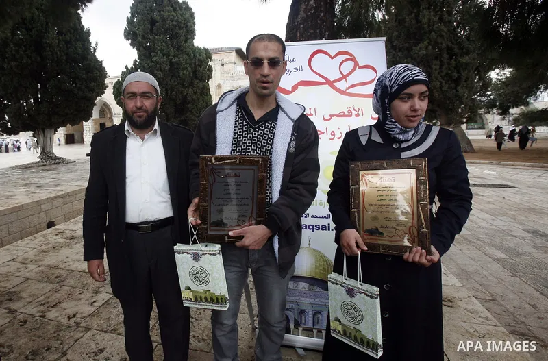 Palestinians attend a ceremony to contract a marriage of two youths in front of the Dome of the Rock, Islam's third holiest, in the old city of Jerusalem on November 12, 2012. Photo by Mahfouz Abu Turk