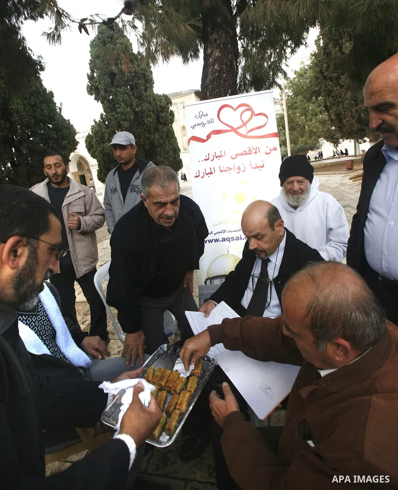 Palestinians attend a ceremony to contract a marriage of two youths in front of the Dome of the Rock, Islam's third holiest, in the old city of Jerusalem on November 12, 2012. Photo by Mahfouz Abu Turk