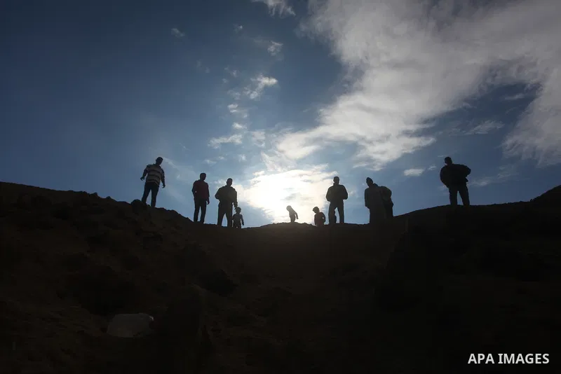 Palestinians inspect damage in their land damaged in an Israeli air strike in Gaza City November 13, 2012. The spike in violence, which comes as Israel is in the middle of an election campaign, raised the spectre of a br...