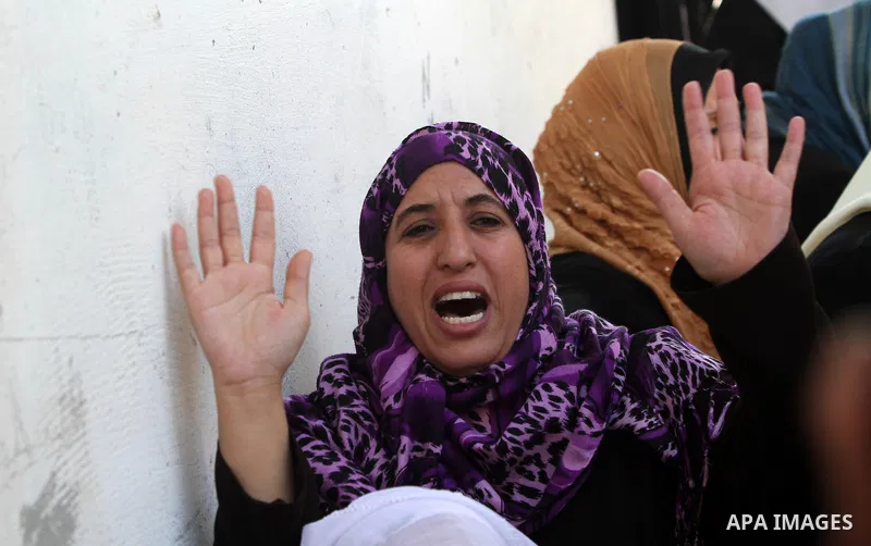 Palestinian relatives of Hamas militant Mohammed Qanoua, who died of wounds suffered from Israeli tank fire, mourn during his funeral in Gaza City November 13, 2012. Israel struck three targets in the Gaza Strip in the e...
