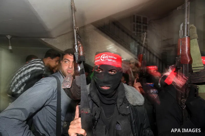Masked Palestinian militants of the Abu Ali Mustapha Brigades, the armed wing of the Popular Front for the Liberation of Palestine, participate a news conference in Gaza City, 13 November 2012. During the press conferenc...