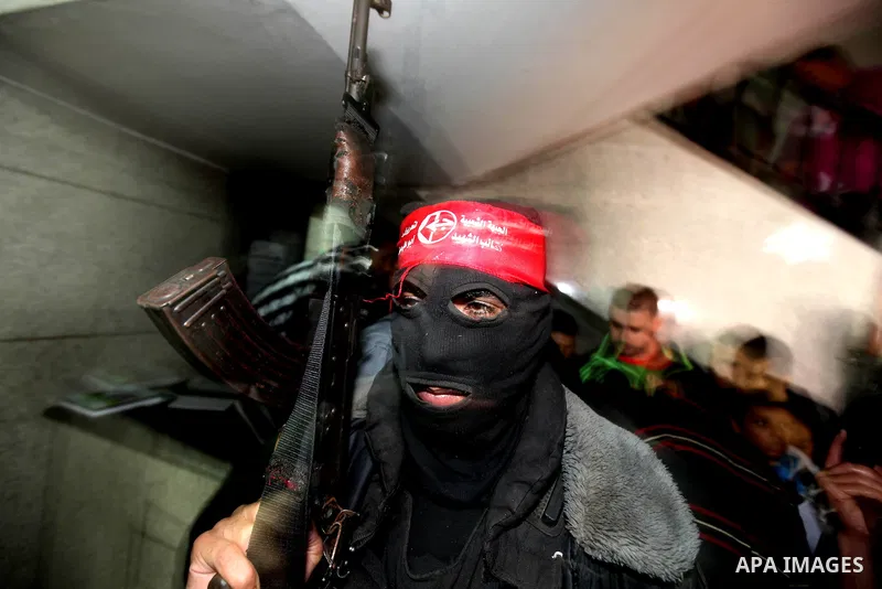 A masked Palestinian militant of the Abu Ali Mustapha Brigades, the armed wing of the Popular Front for the Liberation of Palestine, participates a news conference in Gaza City, 13 November 2012. During the press confere...
