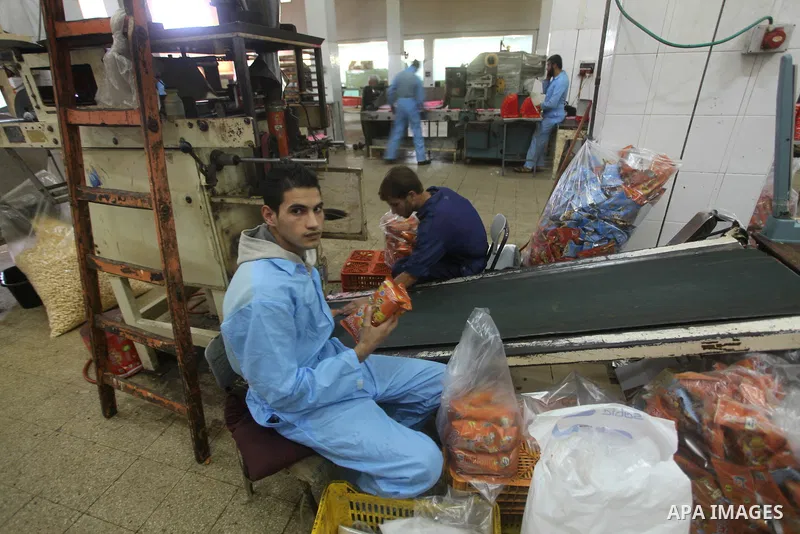 Palestinian labourers work at a factory for making of candy in Gaza city on Nov. 14, 2012. Photo by Ashraf Amra